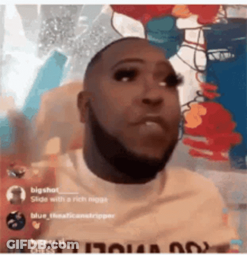 Man With Beard And Fake Eyelashes Before Colorful Wall GIF