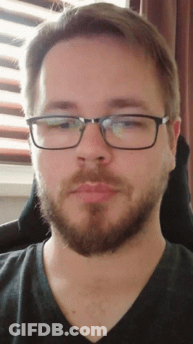 Man With Beard And Glasses Looking At Camera GIF