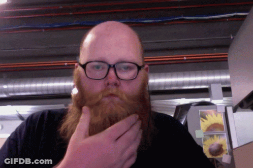 Man With Beard And Glasses Touching Chin GIF