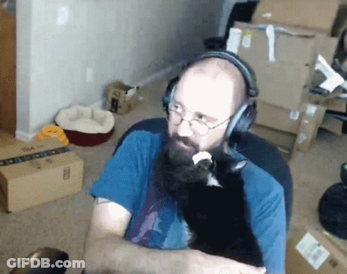 Man With Beard And Glasses Touching Chin GIF