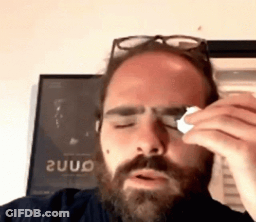 Man With Beard And Glasses Wipes Eye With Napkin GIF