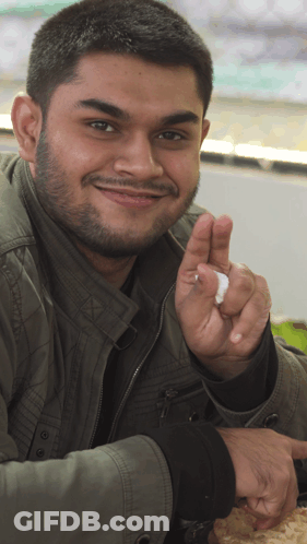 Man With Beard And Green Jacket Giving Peace Sign GIF