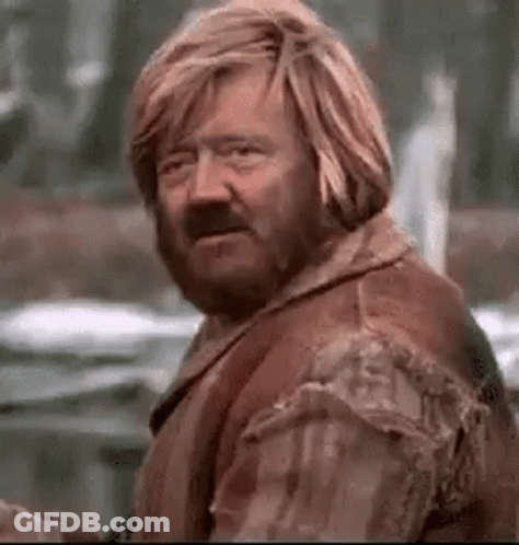 Man With Beard And Long Blonde Hair By Building GIF