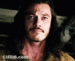 Man With Beard And Long Hair Looking At Camera GIF
