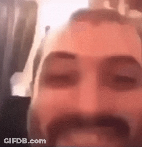 Man With Beard And Mustache Eyes Closed Looking At Camera GIF