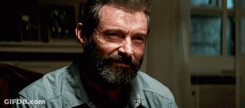 Man With Beard And Mustache In Blue Shirt Sitting In Chair GIF
