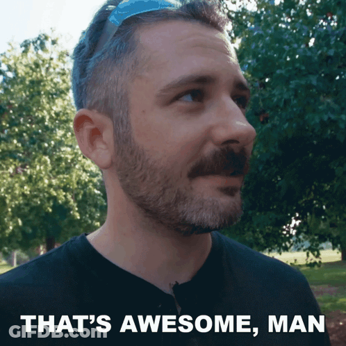 Man With Beard And Mustache Standing In Front Of Trees, Caption That's Awesome Man GIF