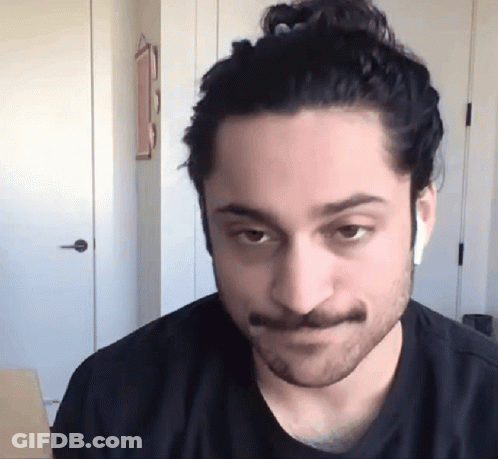 Man With Beard And Mustache Wearing Earbuds GIF