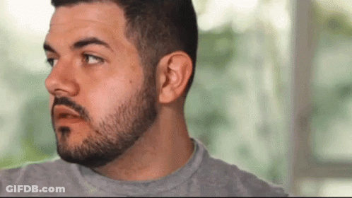 Man With Beard And Mustache Wearing Grey Shirt Making Funny Face GIF