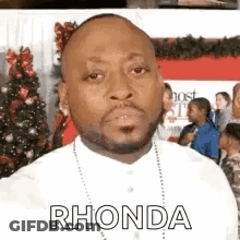 Man With Beard And Necklace In Front Of Christmas Tree GIF