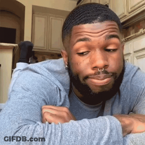 Man With Beard And Nose Ring Lying Down Making Face GIF