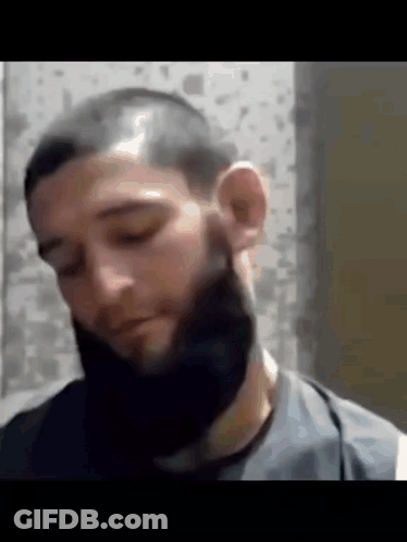Man With Beard And Shaved Head Looking Down GIF