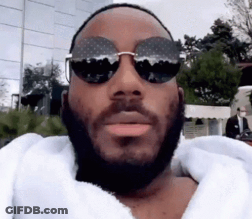 Man With Beard And Sunglasses In White Robe GIF