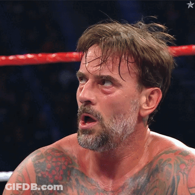 Man With Beard And Tattoos In Boxing Ring With Mouth Open GIF