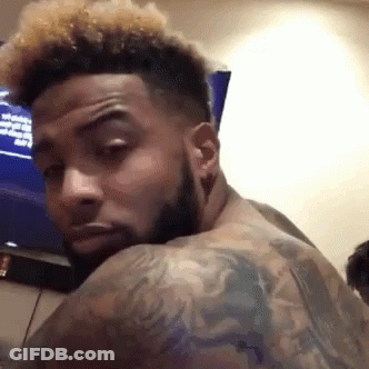 Man With Beard And Tattoos Looking Back GIF