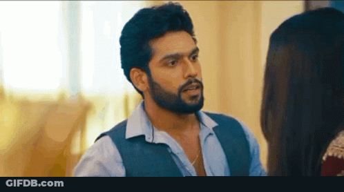 Man With Beard And Vest Talking To Woman GIF