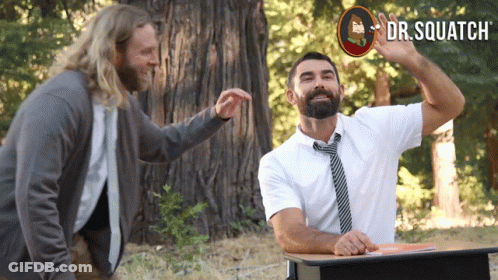 Man With Beard At Desk With Dr. Squatch Sign GIF