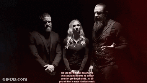 Man With Beard Beside Woman In Black Dress GIF
