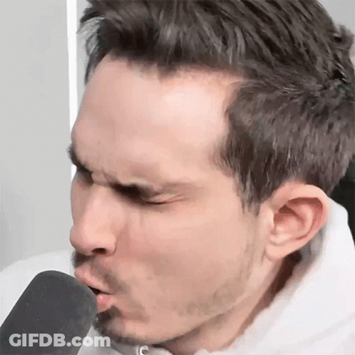 Man With Beard Blowing Into Microphone GIF