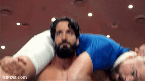 Man With Beard Carried By Man In Blue Shirt GIF