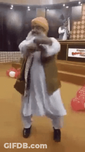 Man With Beard Dancing In Room With Balloons GIF