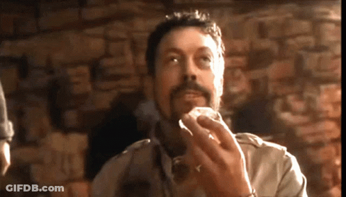 Man With Beard Eating At Stone Wall GIF