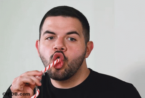 Man With Beard Eating Candy Cane GIF