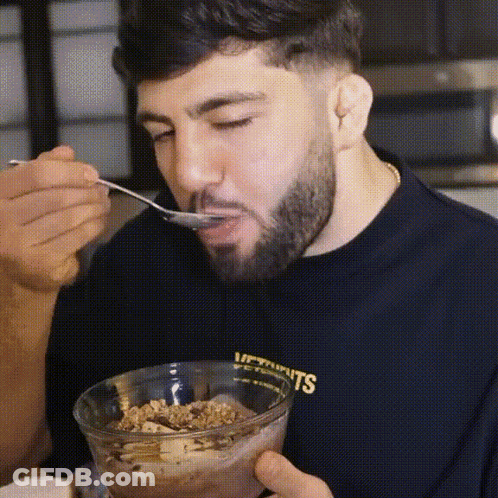 Man With Beard Eating Cereal From Glass Bowl GIF