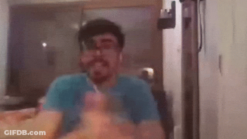Man With Beard Eating Food At Table GIF