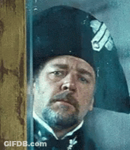 Man With Beard, Hat, Bow Tie At Window GIF