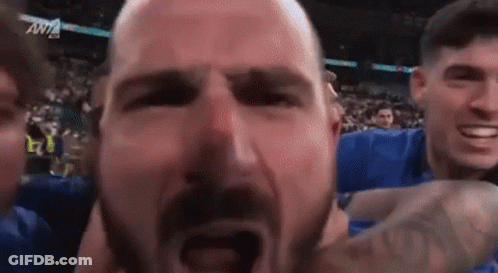 Man With Beard Held By Group GIF