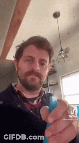 Man With Beard Holding Blue Object GIF