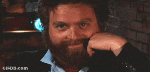 Man With Beard Holding Hand To Ear Smiling GIF