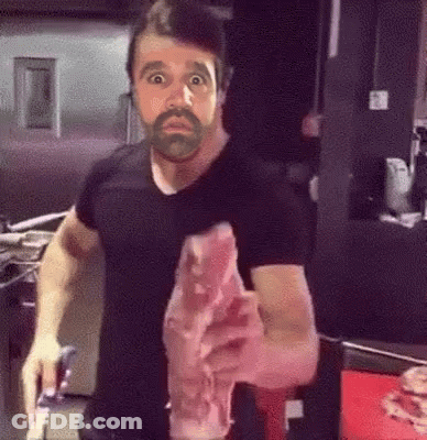 Man With Beard Holding Meat GIF
