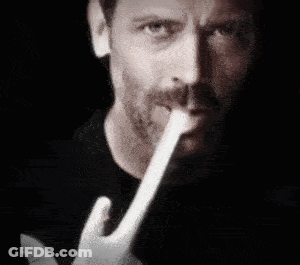 Man With Beard Holding Paper In Mouth GIF