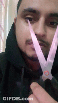 Man With Beard Holding Scissors To Face GIF