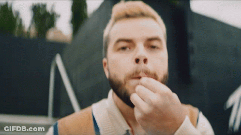 Man With Beard Holding Something In His Mouth GIF