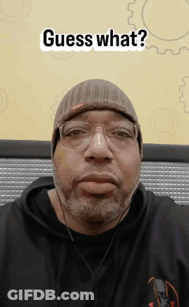 Man With Beard In Beanie And Headphones Says Guess What GIF