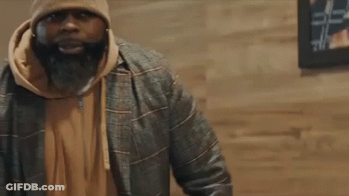 Man With Beard In Beanie And Jacket Talking To Another Man GIF