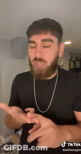 Man With Beard In Black Shirt And Chain GIF
