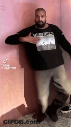 Man With Beard In Black Shirt In Front Of Pink Wall GIF
