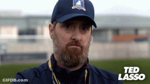 Man With Beard In Blue Hat Saying Ted Lasso GIF