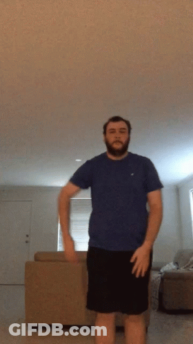 Man With Beard In Blue Shirt And Black Shorts GIF