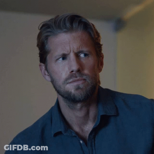 Man With Beard In Blue Shirt Looking At Camera GIF