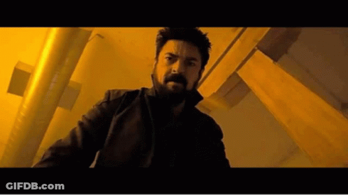 Man With Beard In Dark Room With Yellow Lights GIF