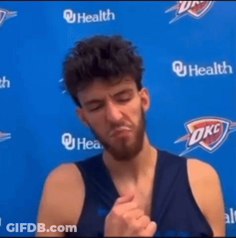 Man With Beard In Front Of Blue OKC Logo GIF