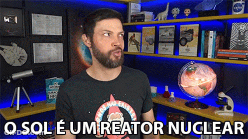 Man With Beard In Front Of Bookshelf Saying O Sole Um Reator Nuclear GIF