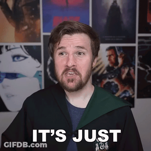 Man With Beard In Front Of Movie Posters GIF