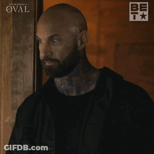 Man With Beard In Front Of Tyler Perry's Oval Sign GIF
