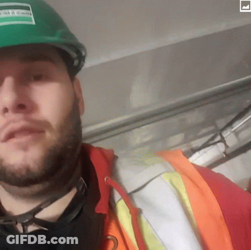Man With Beard In Green Hard Hat And Orange Jacket GIF